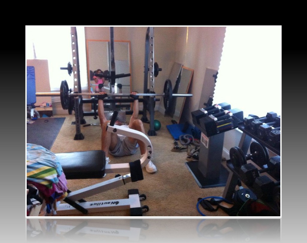 We have a half cage squat rack, which my husband Brian is using for floor bench presses