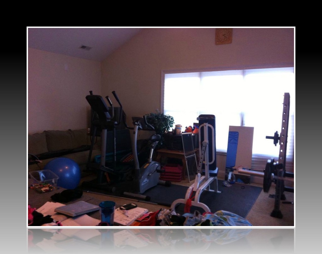 Our poor neglected elliptical and upright bike. They don't get a lot of use...To the right is a blue incline bench.